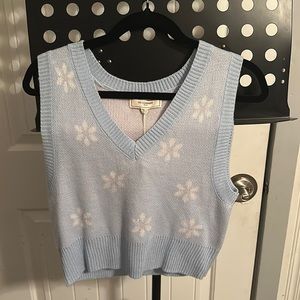 Blue knit sweater vest with white flowers